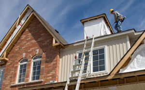 Roofing worker on ladder